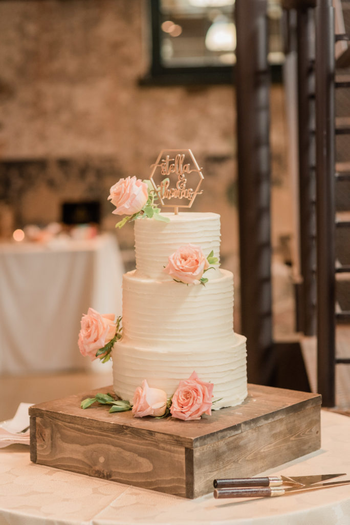 wedding Cake on display with pink roses