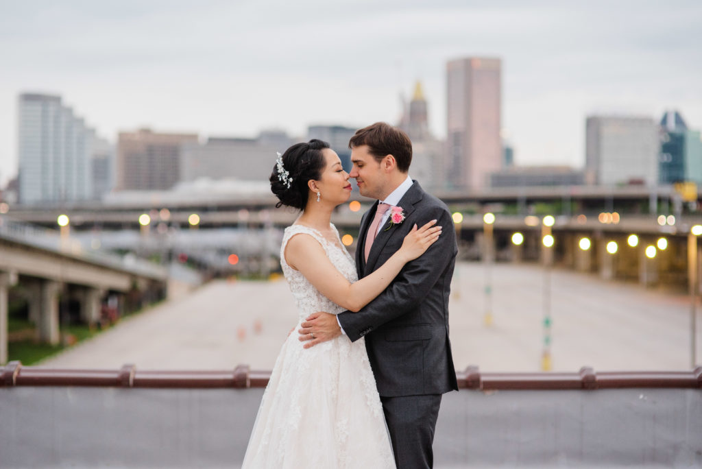 Bride and groom portraits on the roof of the winslow with the Baltimore skyline in the background