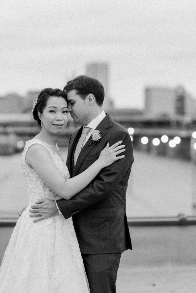 Bride and groom portraits on the roof of the winslow with the Baltimore skyline in the background